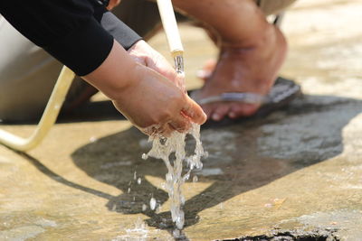 Midsection of man holding umbrella