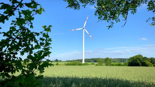 A photo of a wind turbine in nature