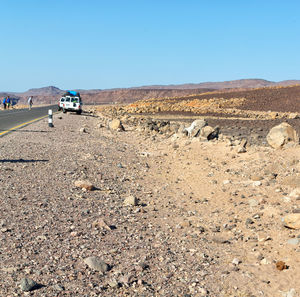 Scenic view of desert against clear blue sky