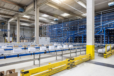 Cardboard boxes on conveyor belt in warehouse