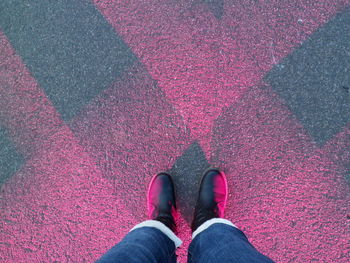 Low section of person standing on tiled floor