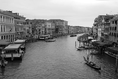 Boats in city against sky