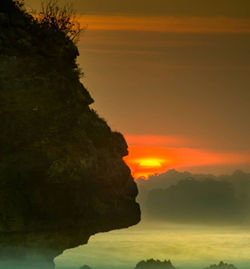 Scenic view of sea against orange sky