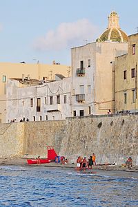 People in front of sea