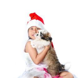 Midsection of a woman with dog against white background