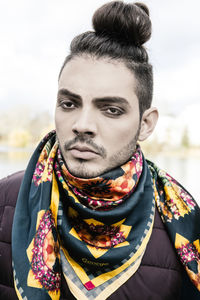 Close-up portrait of man against sky