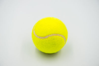 Close-up of yellow ball on white background