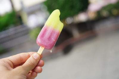 Close-up of hand holding ice cream cone