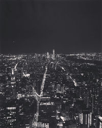 High angle view of illuminated cityscape against sky at night