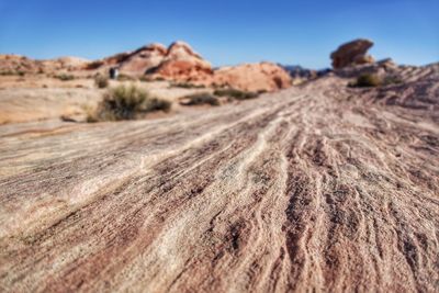 Surface level of desert against sky