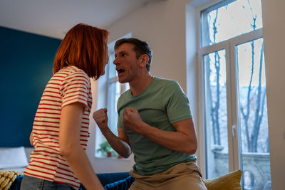 Side view of woman exercising at home