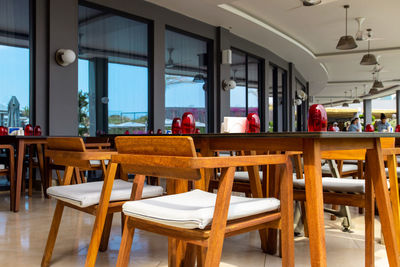 Empty chairs and tables in restaurant