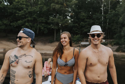 Smiling friends at lake