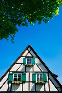 Low angle view of building against clear blue sky