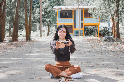 Full length portrait of senior man sitting outdoors