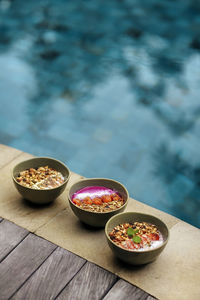 Three ready to eat bowls of strawberry, peanut butter and pitaya muesli