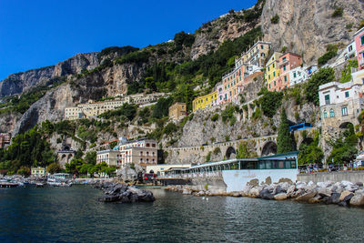 View of the town of amalfi from the jetty with the sea and the colorful houses 