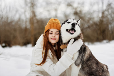 Portrait of dog standing on snow