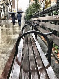 Low section of man walking on road in rain