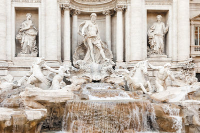 Statues and fountain outside historical building