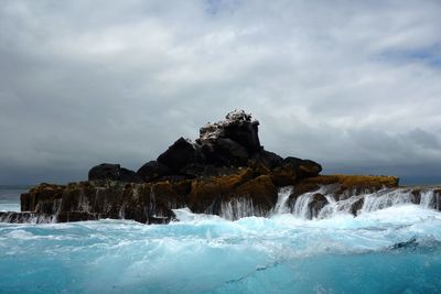 Low angle view of rock formation in sea