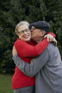 Old man kissing wife on the cheek