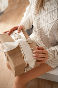 Midsection of woman holding book