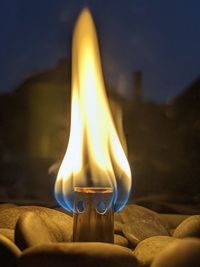 Close-up of lit candle against blurred background