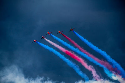 Low angle view of airshow against sky