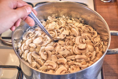 Close-up of person preparing food in bowl on table