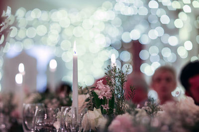 Illuminated candles on table