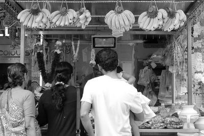Rear view of people at market stall