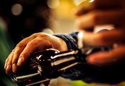 Cropped hand of man holding beer bottle