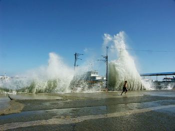 Water splashing in fountain against sky