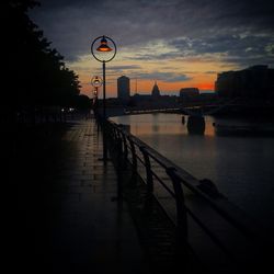 Bridge over river at sunset