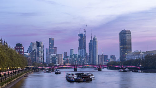 Bridge over river against cloudy sky