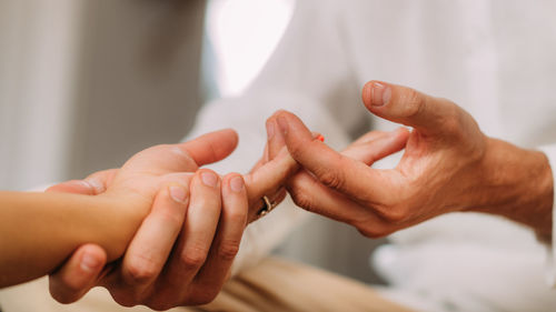 Shiatsu hand massage. therapist massaging the heart meridian.