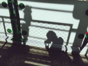 Shadow of people sitting on bridge