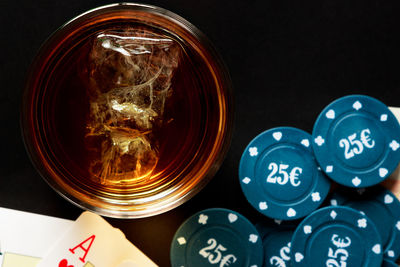 High angle view of glasses on table against black background