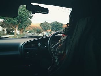 Vehicles on road seen through car windshield