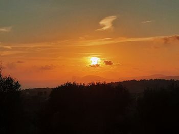 Scenic view of silhouette landscape against romantic sky at sunset