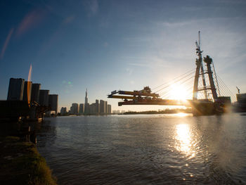 Commercial dock by sea against sky in city