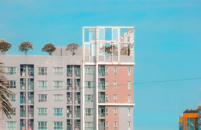 Low angle view of buildings against blue sky