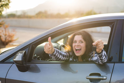 Portrait of young woman in car