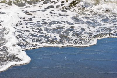 High angle view of surf on beach