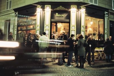 Blurred motion of woman in city at night