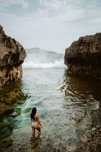 High angle view of boy playing in sea