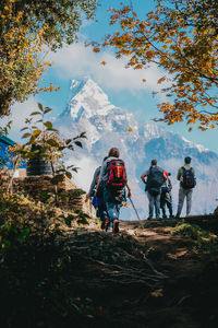 People on mountain against sky