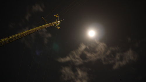 Low angle view of illuminated moon at night