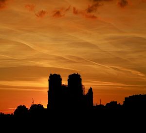 Silhouette buildings against sky during sunset